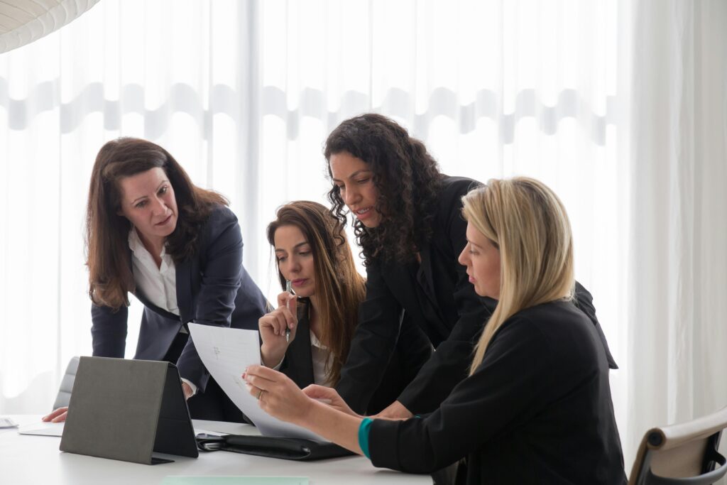 Women in Blazers Having a Meeting in an Office